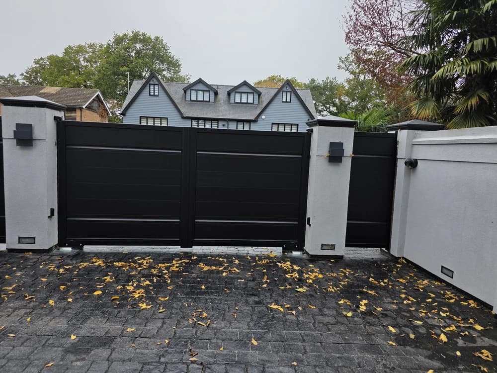 Black contemporary double swing driveway gates in daylight