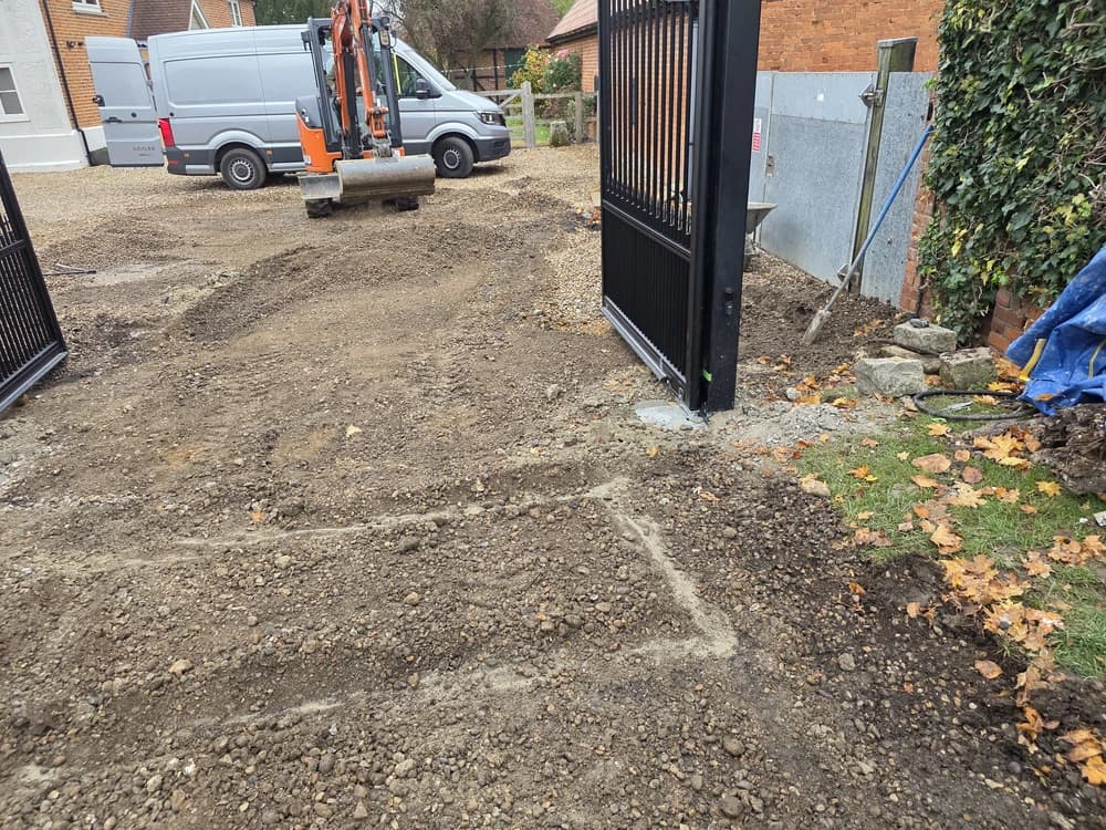 Groundwork in progress for a black metal driveway gate
