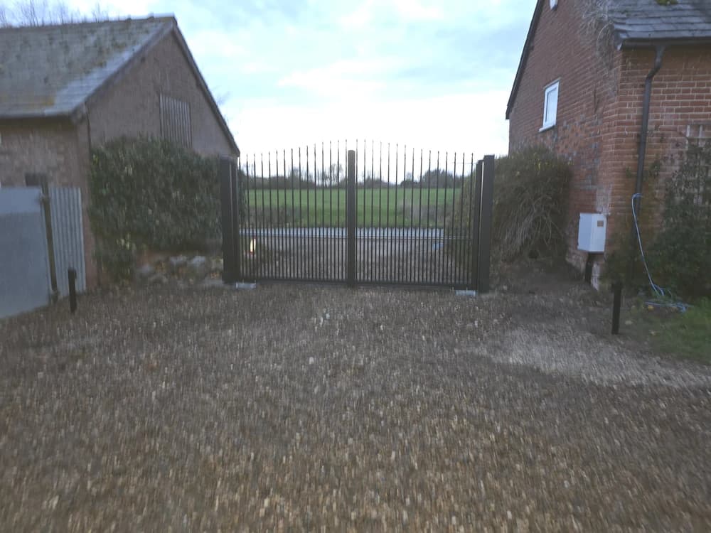 Black metal spear-top estate gates in a countryside setting