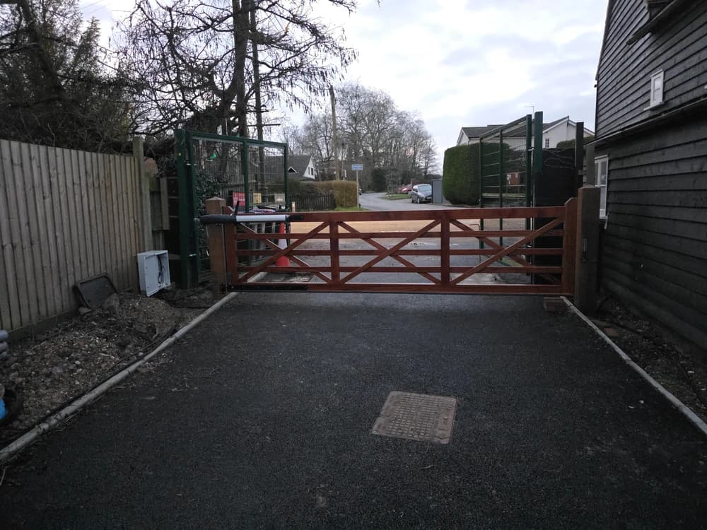 Timber five-bar field gate at a driveway entrance