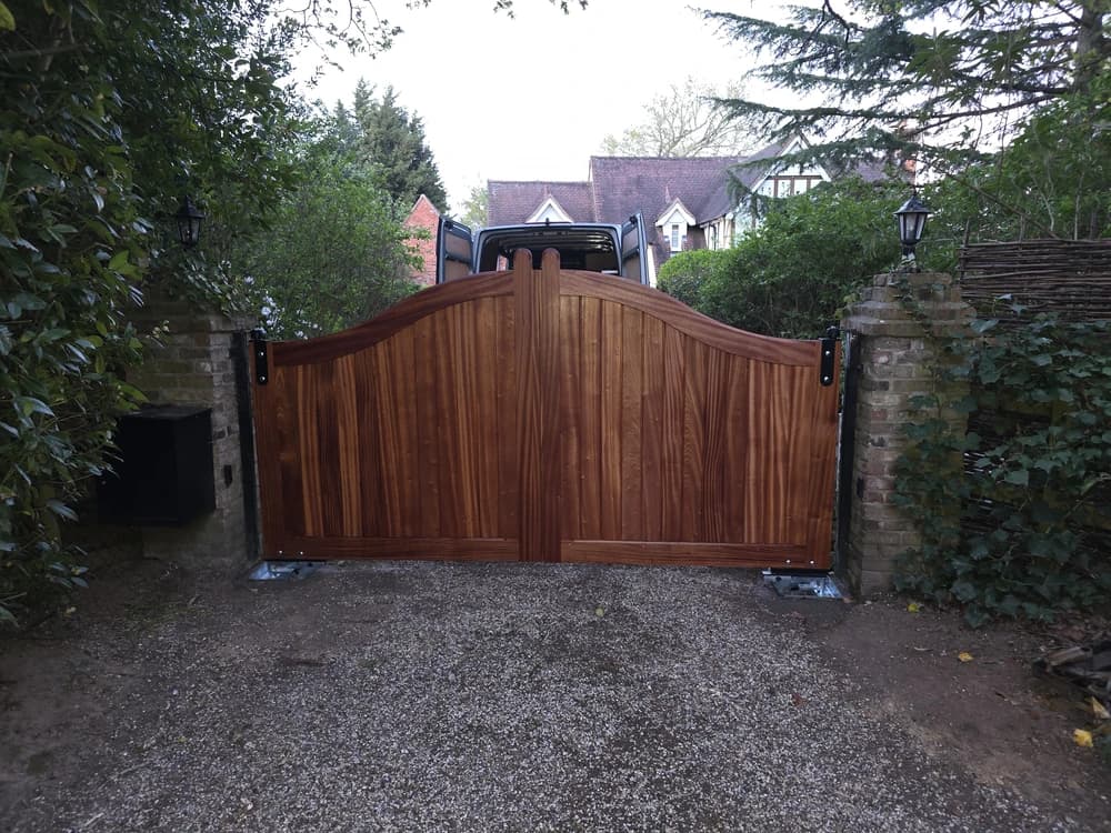 Hardwood swan-neck double swing gates in tongue-and-groove