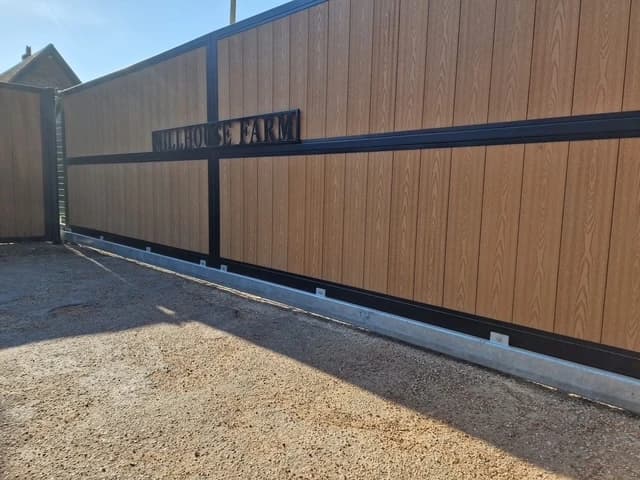 Side view of an oak-effect composite cantilever sliding gate