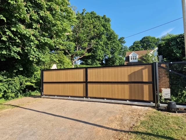 Front view of an oak-effect composite cantilever sliding gate