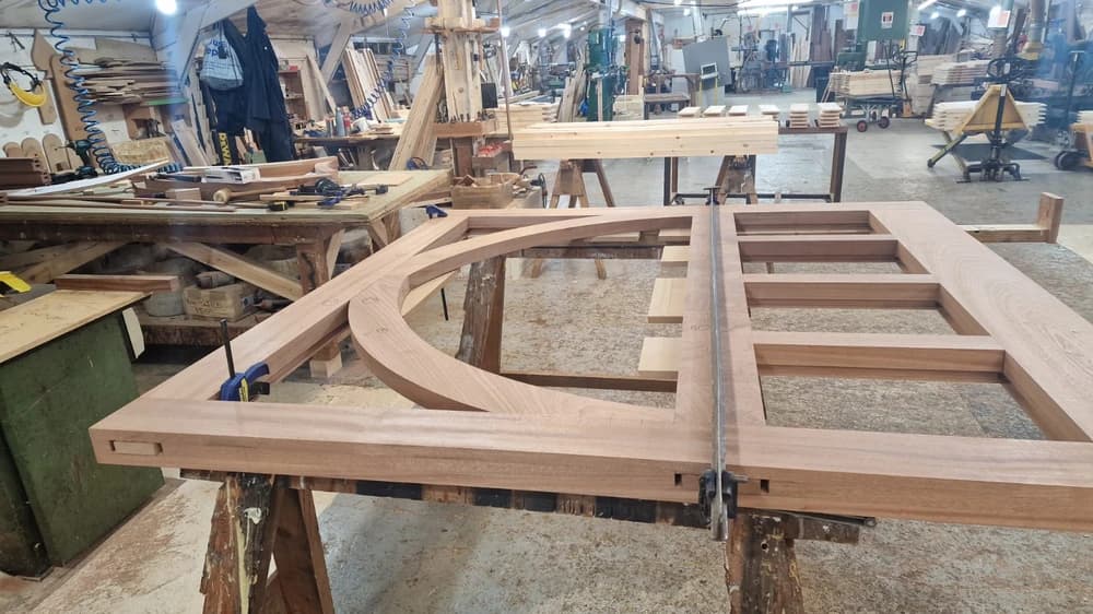 Arched hardwood gate frame clamped up in the workshop