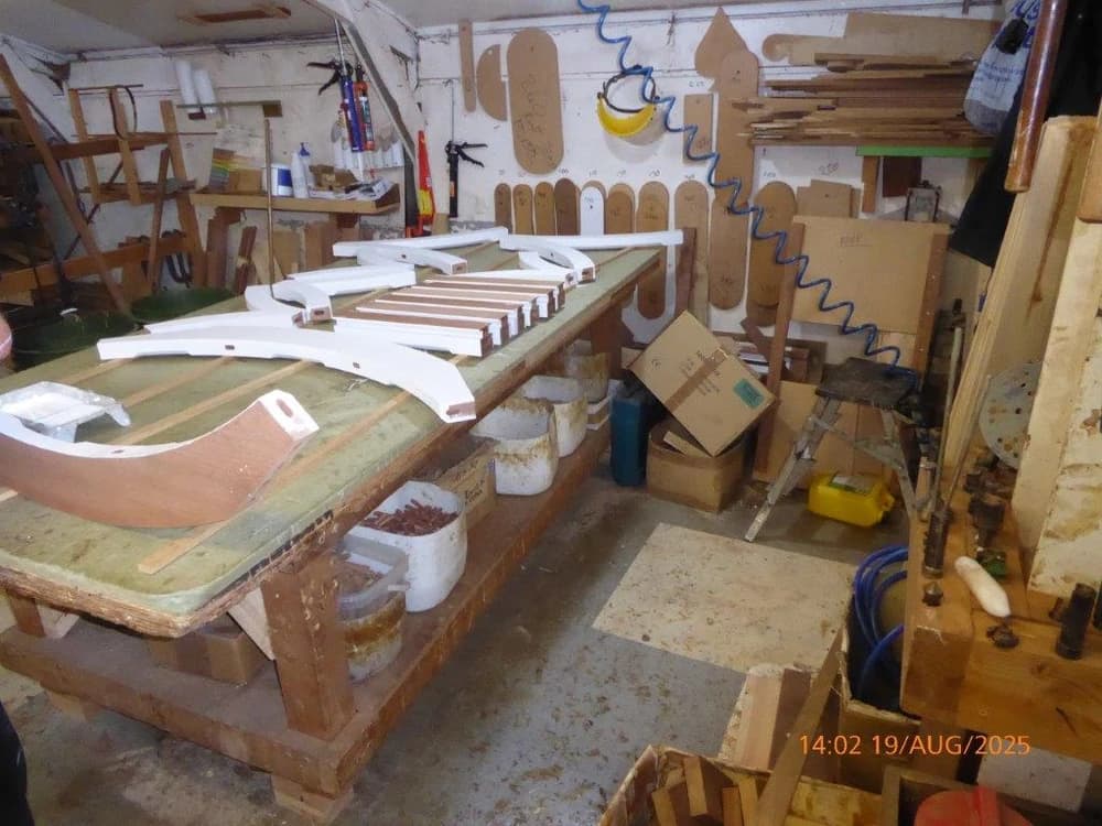 Primed swan-neck hardwood rails in the workshop