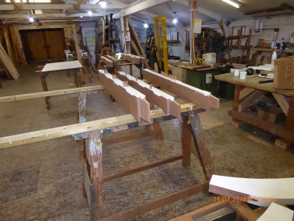 Hardwood gate rails set out on trestles in the workshop